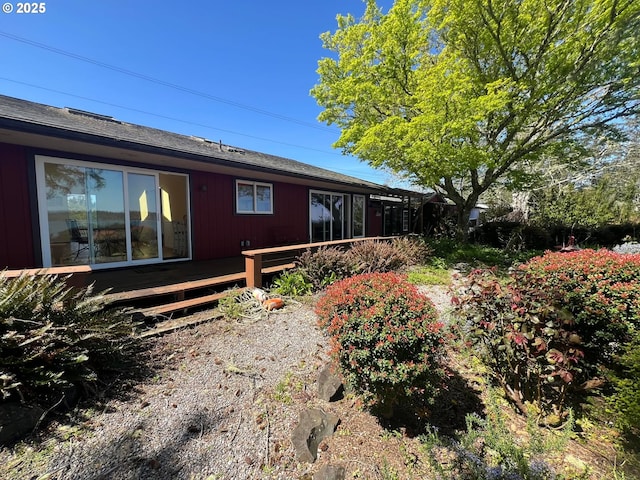 rear view of property featuring a deck