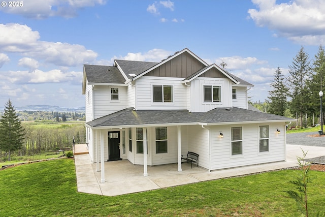 39313 NE 143rd Pl, Amboy, WA 98601 - back of property featuring a lawn, a shingled roof, board and batten siding, and a patio area