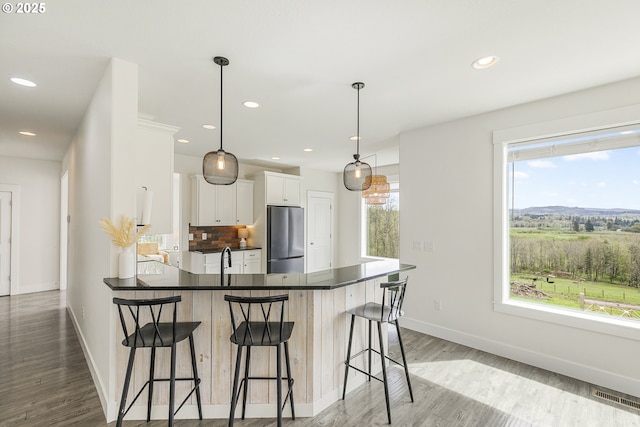 39313 NE 143rd Pl, Amboy, WA 98601 - kitchen with dark countertops, plenty of natural light, freestanding refrigerator, and visible vents