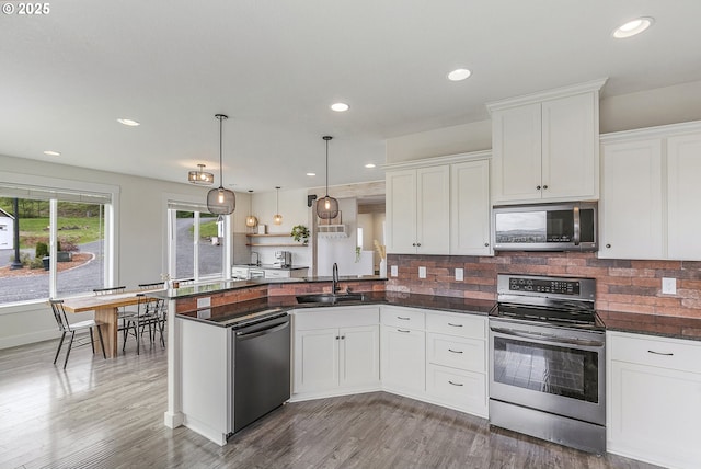 39313 NE 143rd Pl, Amboy, WA 98601 - kitchen featuring stainless steel appliances, white cabinetry, a sink, and a peninsula