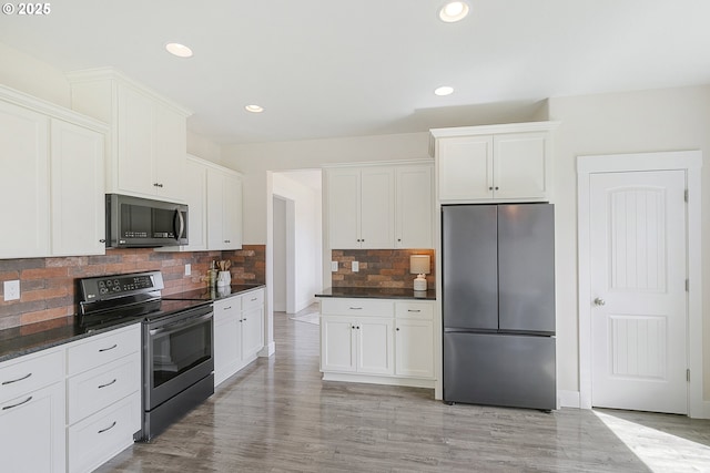 39313 NE 143rd Pl, Amboy, WA 98601 - kitchen featuring recessed lighting, tasteful backsplash, white cabinets, and stainless steel appliances