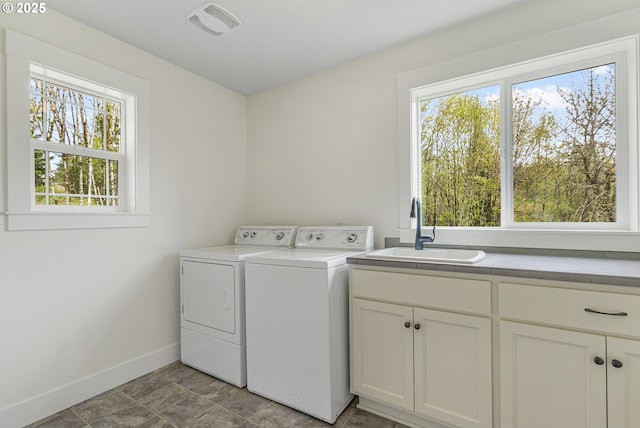 39313 NE 143rd Pl, Amboy, WA 98601 - washroom featuring cabinet space, washing machine and dryer, a sink, and a wealth of natural light