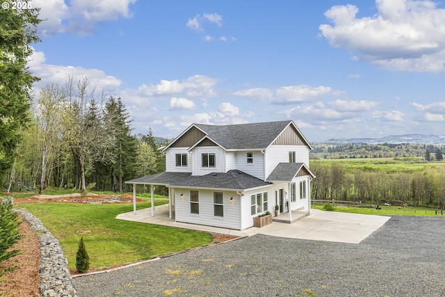 39313 NE 143rd Pl, Amboy, WA 98601 - view of property exterior featuring a shingled roof, a yard, a patio area, and driveway