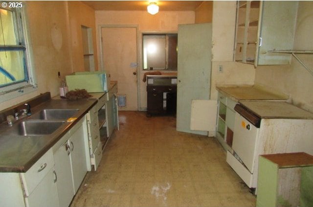 509 Dyke Rd, Dillard, OR 97432 - kitchen featuring white cabinets, dark countertops, light floors, and a sink