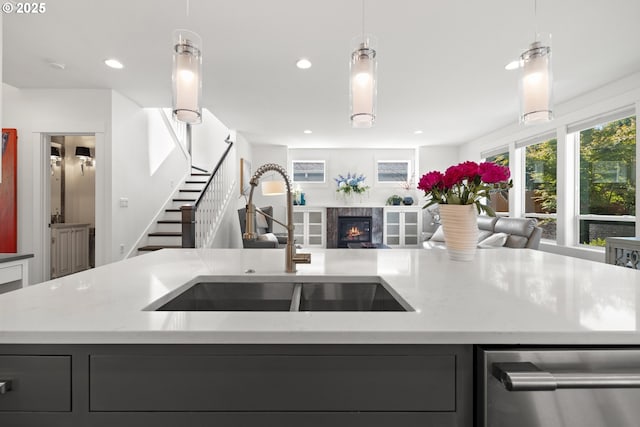 2608 N Winchell St, Portland, OR 97217 - kitchen featuring open floor plan, a sink, stainless steel dishwasher, an island with sink, and light stone counters