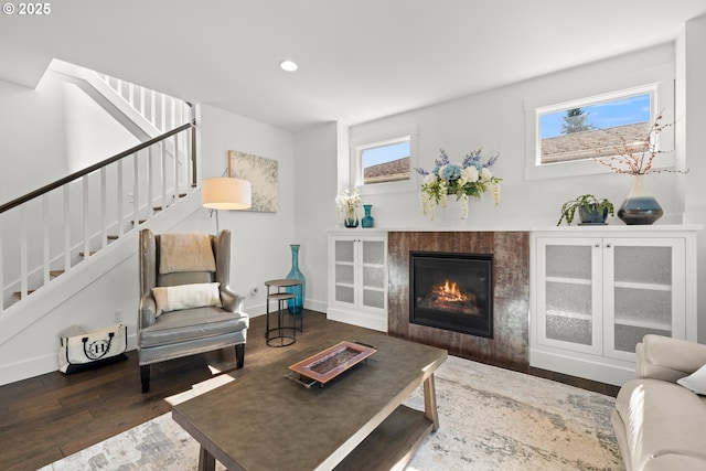 2608 N Winchell St, Portland, OR 97217 - living area with stairs, wood finished floors, recessed lighting, a tile fireplace, and baseboards