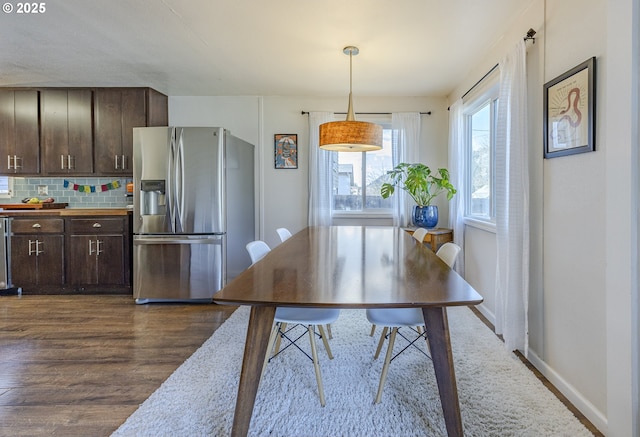 dining room with dark wood finished floors and baseboards