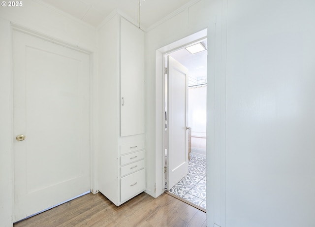 interior space with light wood-type flooring and crown molding