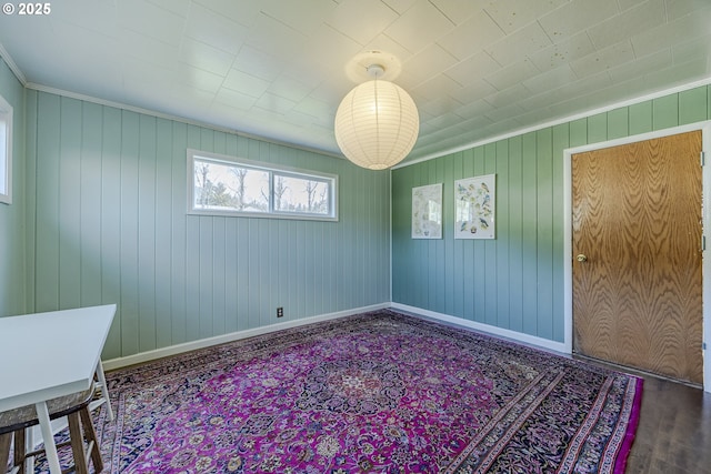 empty room featuring wood finished floors and baseboards