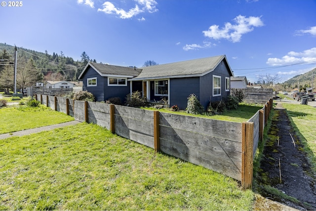 single story home with a front yard and fence