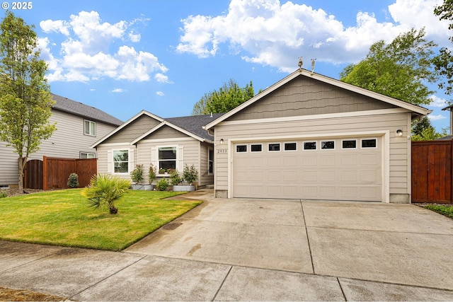 ranch-style home featuring fence, driveway, a front yard, and a garage