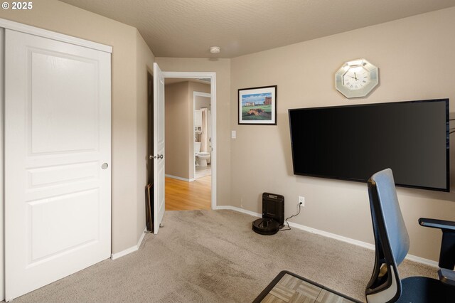 office area with baseboards and light carpet