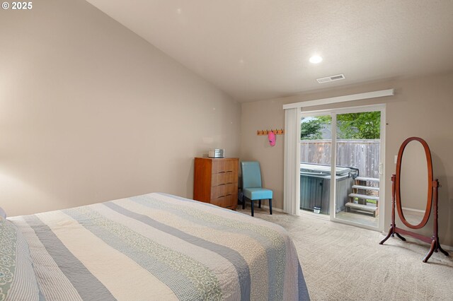 carpeted bedroom featuring access to outside, baseboards, and visible vents
