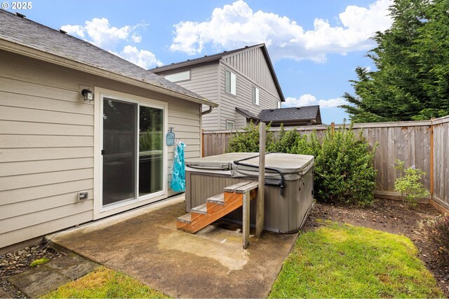 view of patio with a fenced backyard and a hot tub