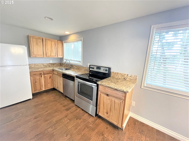 kitchen with a sink, light brown cabinetry, stainless steel appliances, dark wood finished floors, and recessed lighting