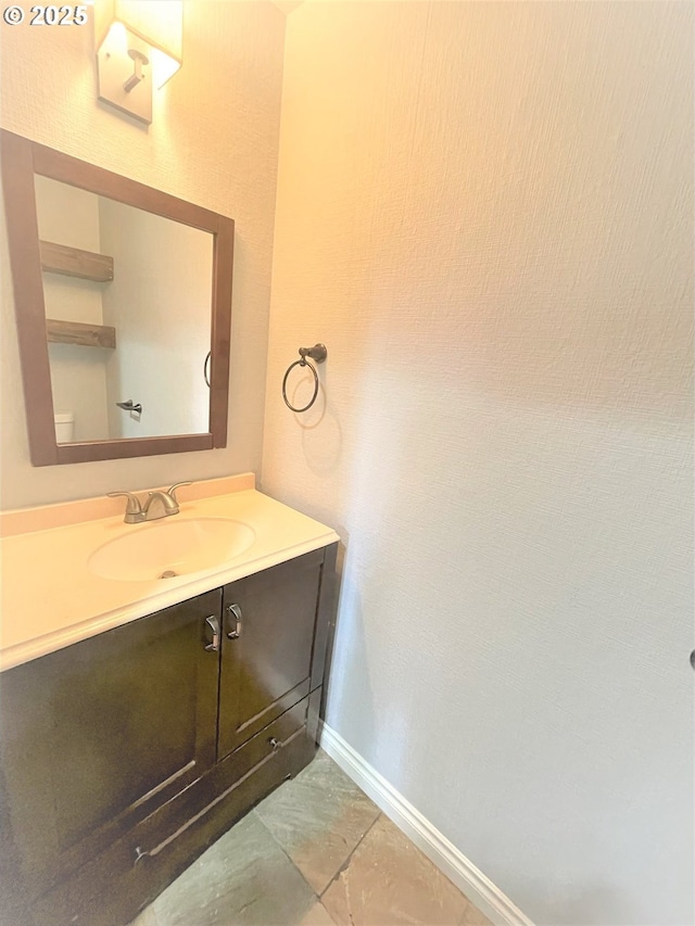 bathroom featuring baseboards and vanity