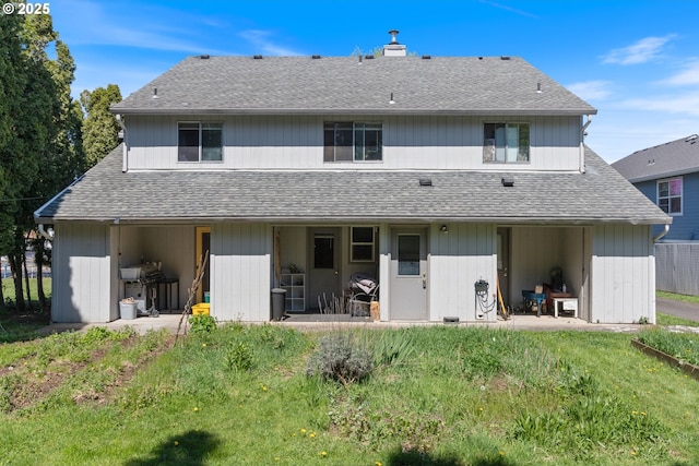 back of house with roof with shingles and a patio