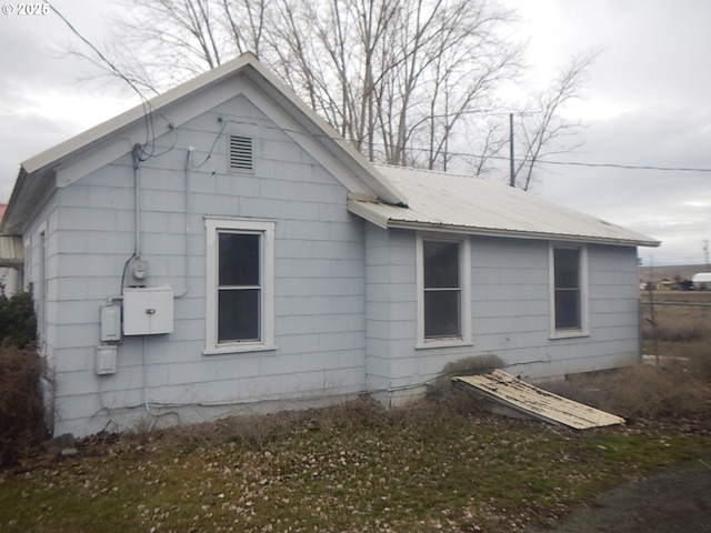 view of side of property with metal roof