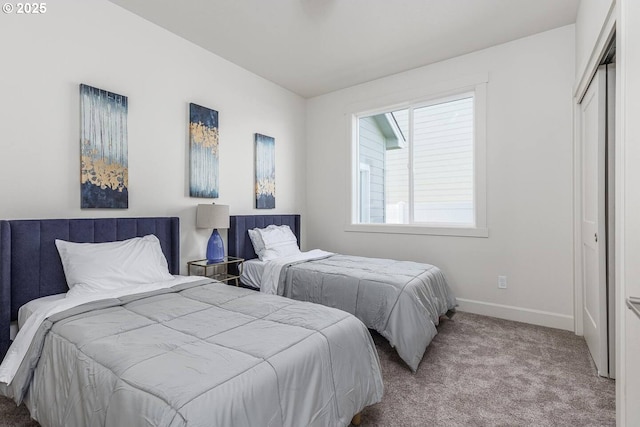 carpeted bedroom featuring baseboards
