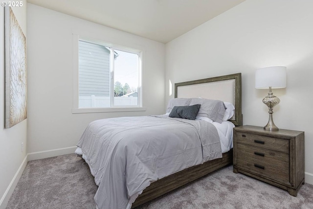 bedroom with light carpet and baseboards