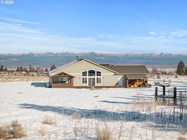 snow covered property with a mountain view