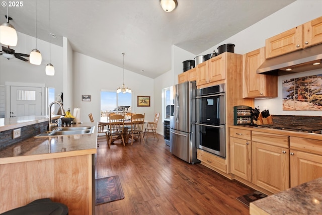 kitchen with light brown cabinetry, sink, pendant lighting, and stainless steel appliances