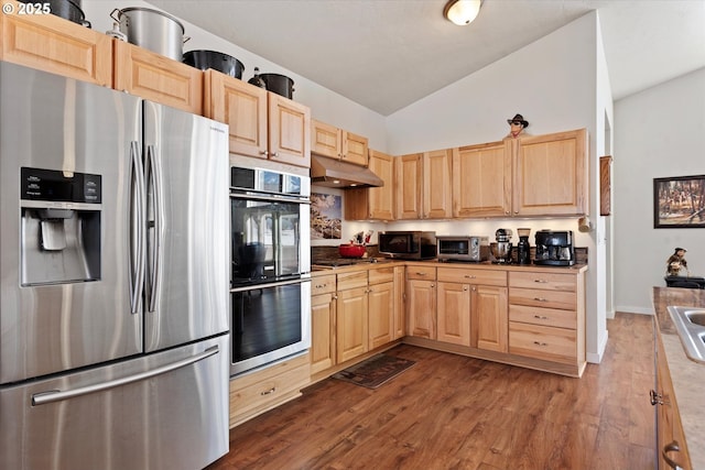 kitchen featuring light brown cabinetry, dark wood-type flooring, high vaulted ceiling, and stainless steel appliances