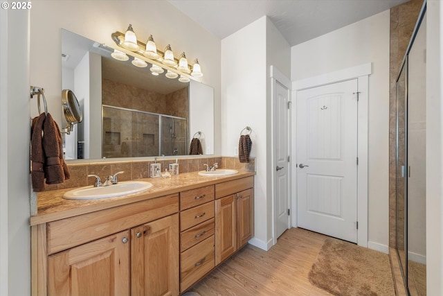 bathroom featuring hardwood / wood-style flooring, an enclosed shower, and vanity