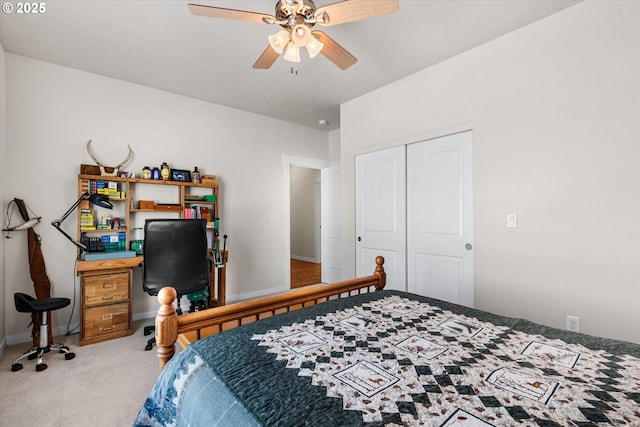 carpeted bedroom with ceiling fan and a closet