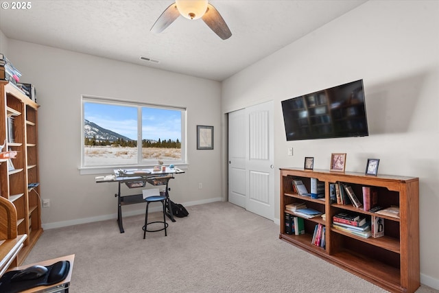 office space with light carpet and ceiling fan