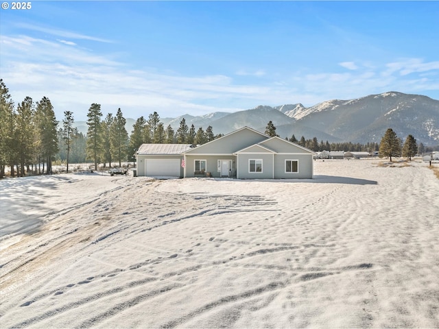 ranch-style home with a mountain view and a garage