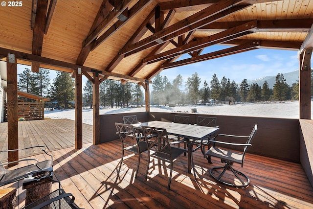 snow covered deck with a mountain view