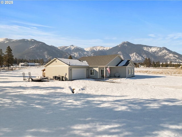 single story home featuring a mountain view and a garage