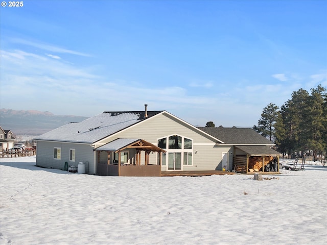 snow covered house with a mountain view