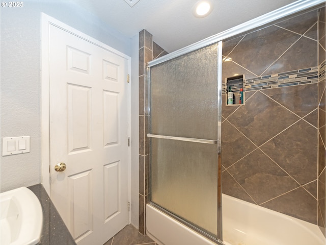 bathroom featuring vanity and bath / shower combo with glass door