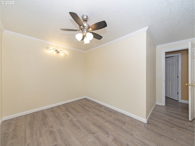 empty room with hardwood / wood-style flooring, ornamental molding, and a textured ceiling