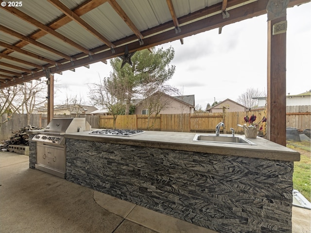 view of patio / terrace featuring exterior kitchen, a grill, and sink