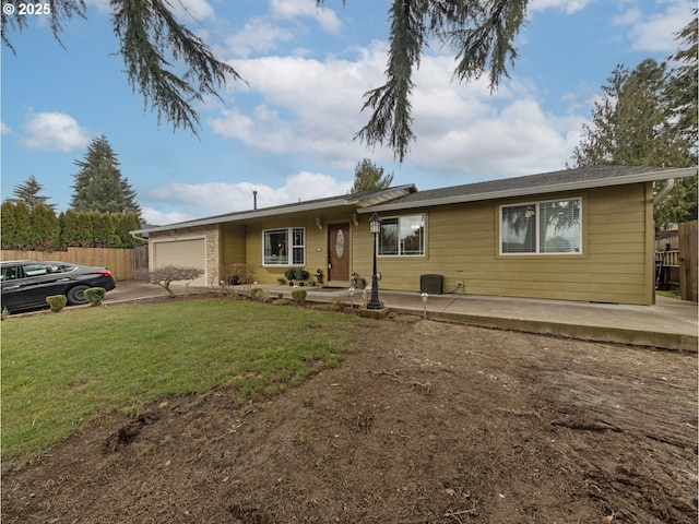 ranch-style house featuring a garage and a front yard