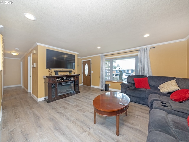 living room with ornamental molding, a textured ceiling, and light hardwood / wood-style floors