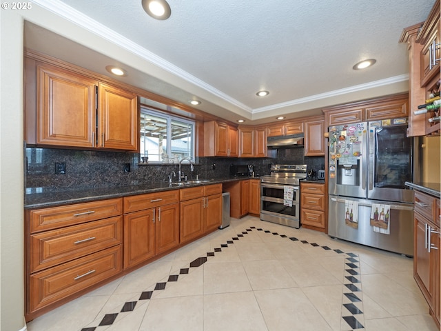 kitchen with sink, dark stone countertops, backsplash, stainless steel appliances, and light tile patterned flooring