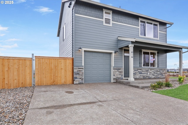 view of front of home with covered porch and a garage