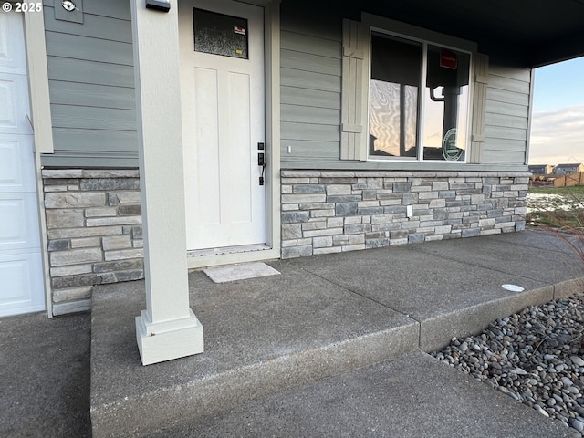 doorway to property featuring covered porch