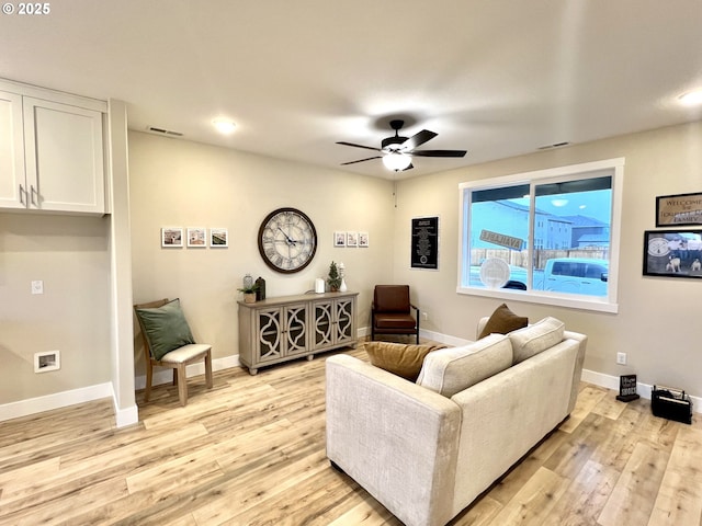 living room with ceiling fan and light wood-type flooring