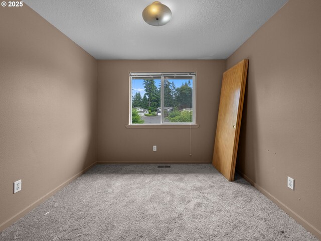 17555 Koch Ct, Sandy, OR 97055 - carpeted empty room with a textured ceiling and baseboards