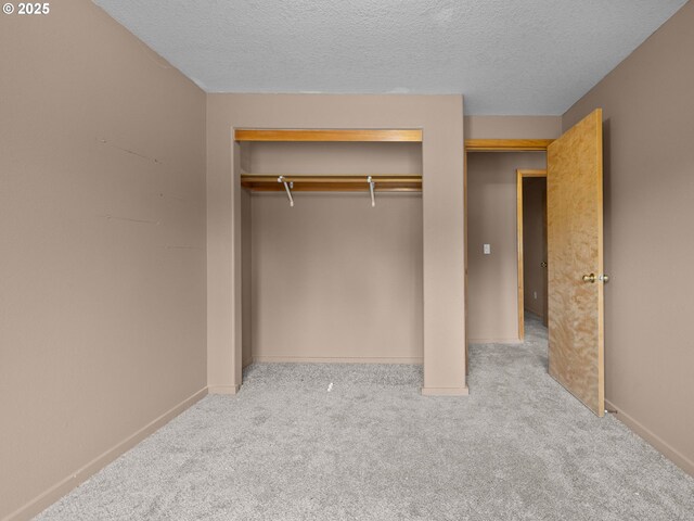 17555 Koch Ct, Sandy, OR 97055 - unfurnished bedroom with carpet, a closet, a textured ceiling, and baseboards