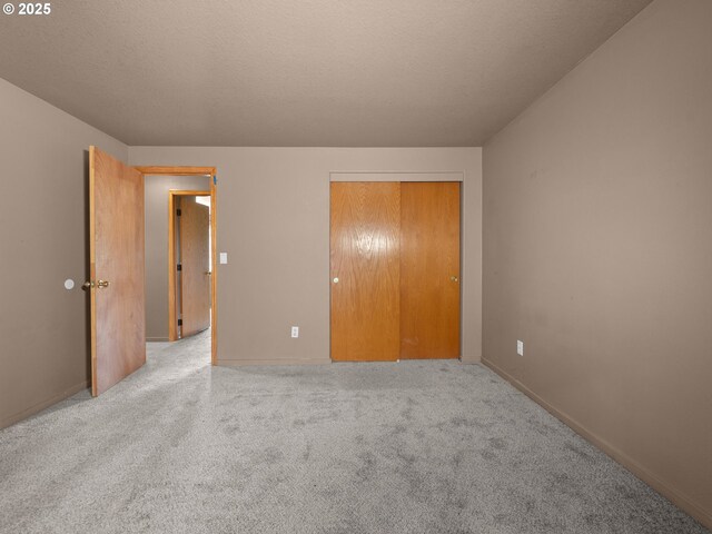 17555 Koch Ct, Sandy, OR 97055 - unfurnished bedroom featuring carpet floors, a closet, a textured ceiling, and baseboards