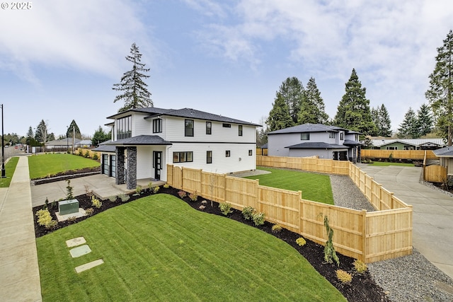 view of front of house with fence and a front yard