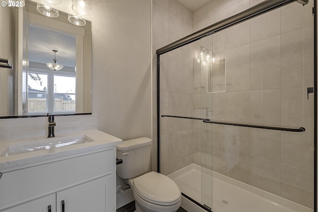 full bathroom featuring toilet, vanity, and a stall shower