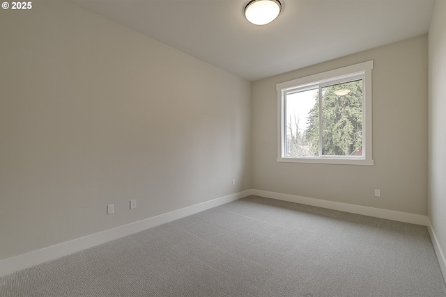 empty room with carpet floors and baseboards