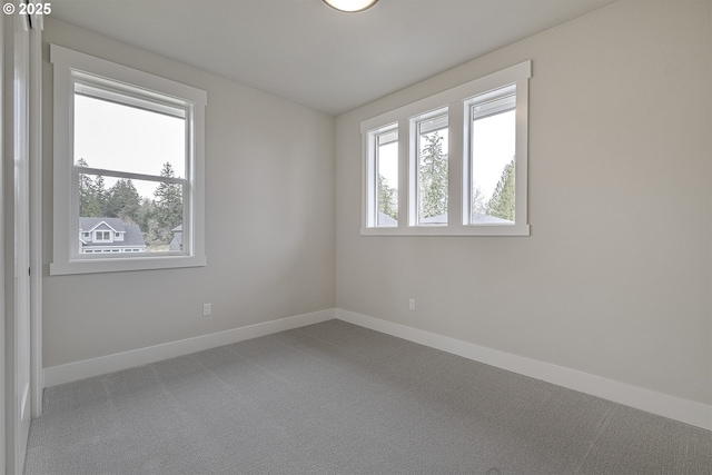 carpeted empty room with baseboards